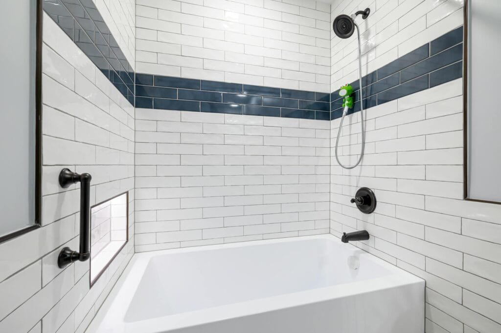 a white and black themed bathroom with square bathtub